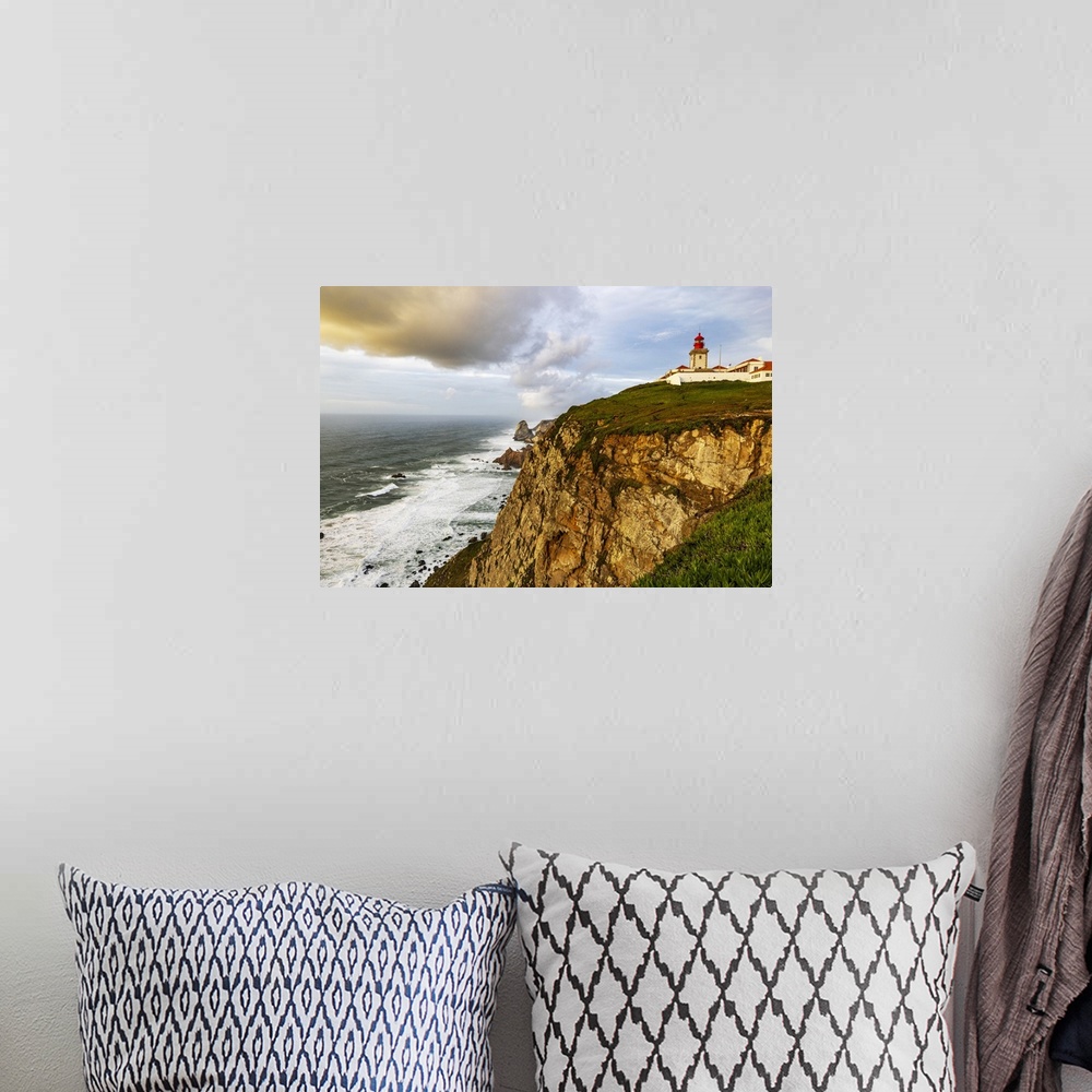 A bohemian room featuring Cabo do Roca Lighthouse at last light in Colares, Portugal.