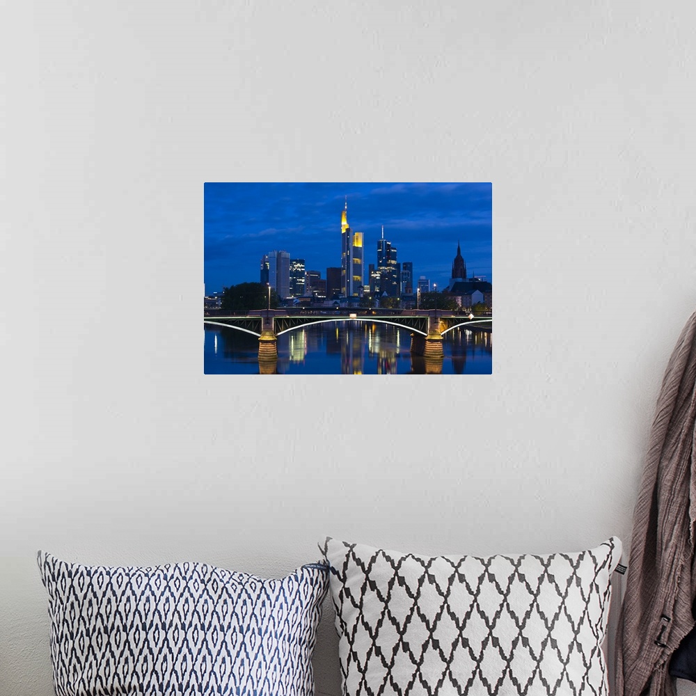 A bohemian room featuring GERMANY, Hessen, Frankfurt am Main. Skyline from Main River and Ignatz Bubis Brucke bridge, dawn.