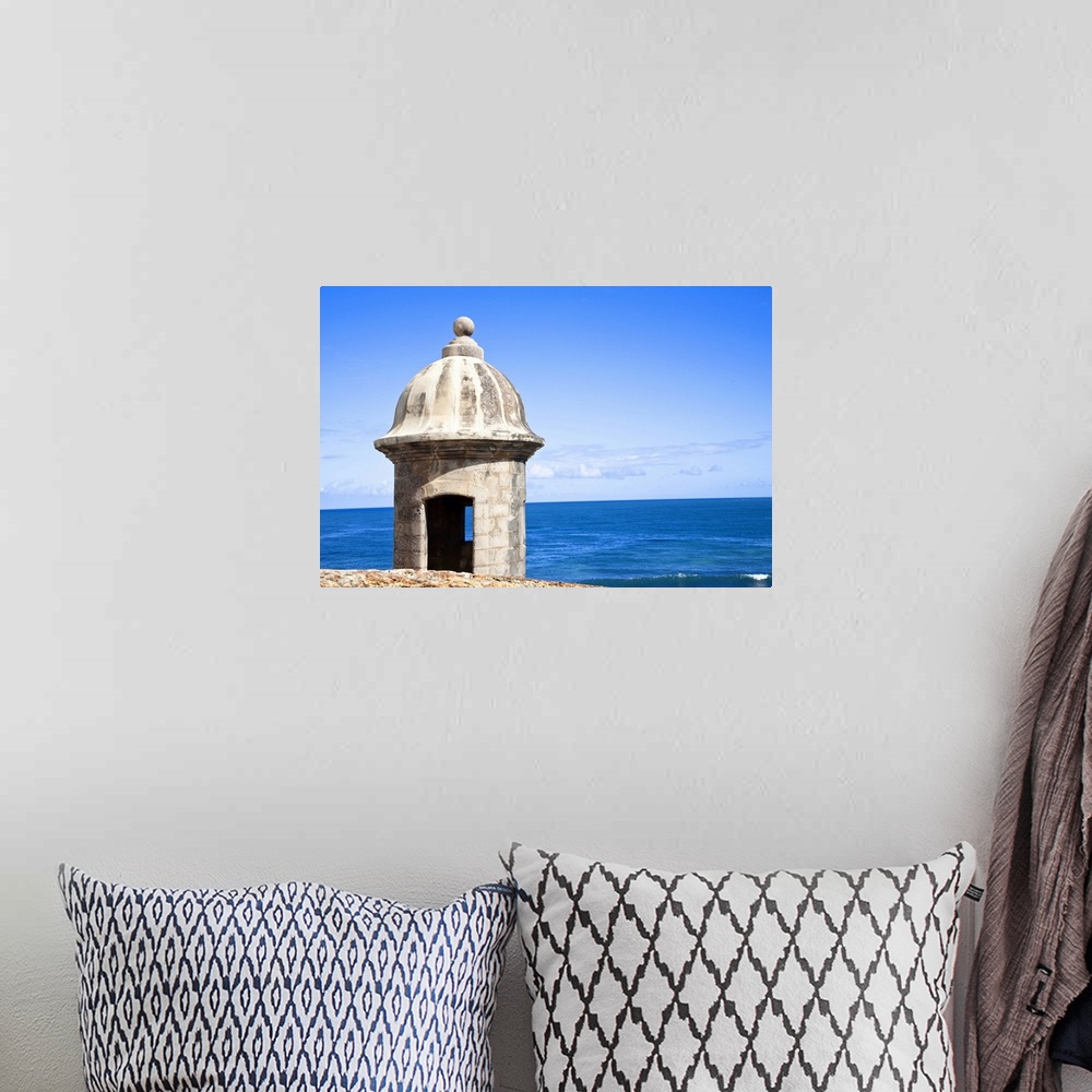 A bohemian room featuring San Juan, Puerto Rico - An old stone watchtower looks out over the ocean. Horizontal shot.