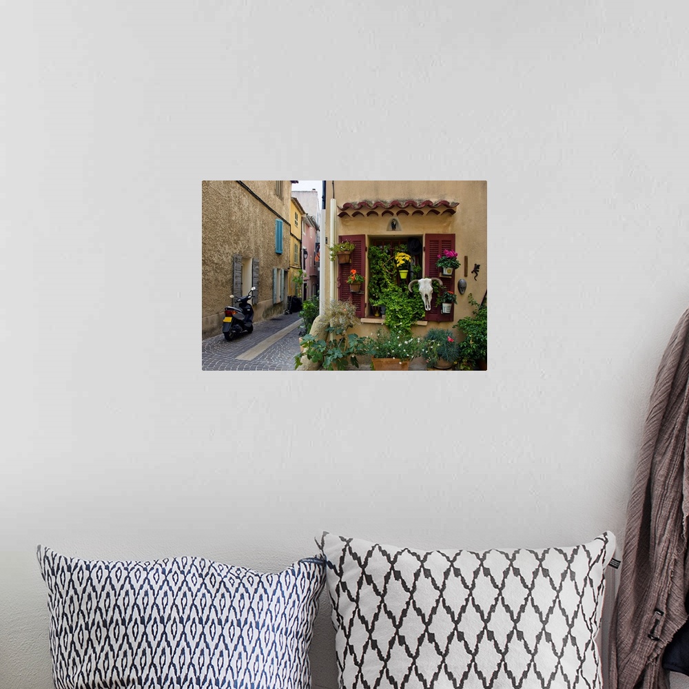 A bohemian room featuring The seaside town of cassis, old street, European town, a journey through France.