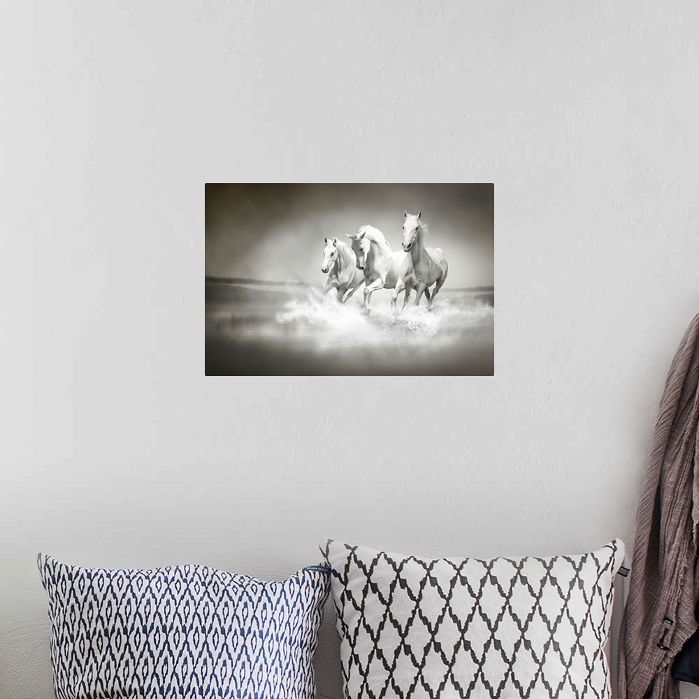 A bohemian room featuring Photo of a herd of white horses running through water.