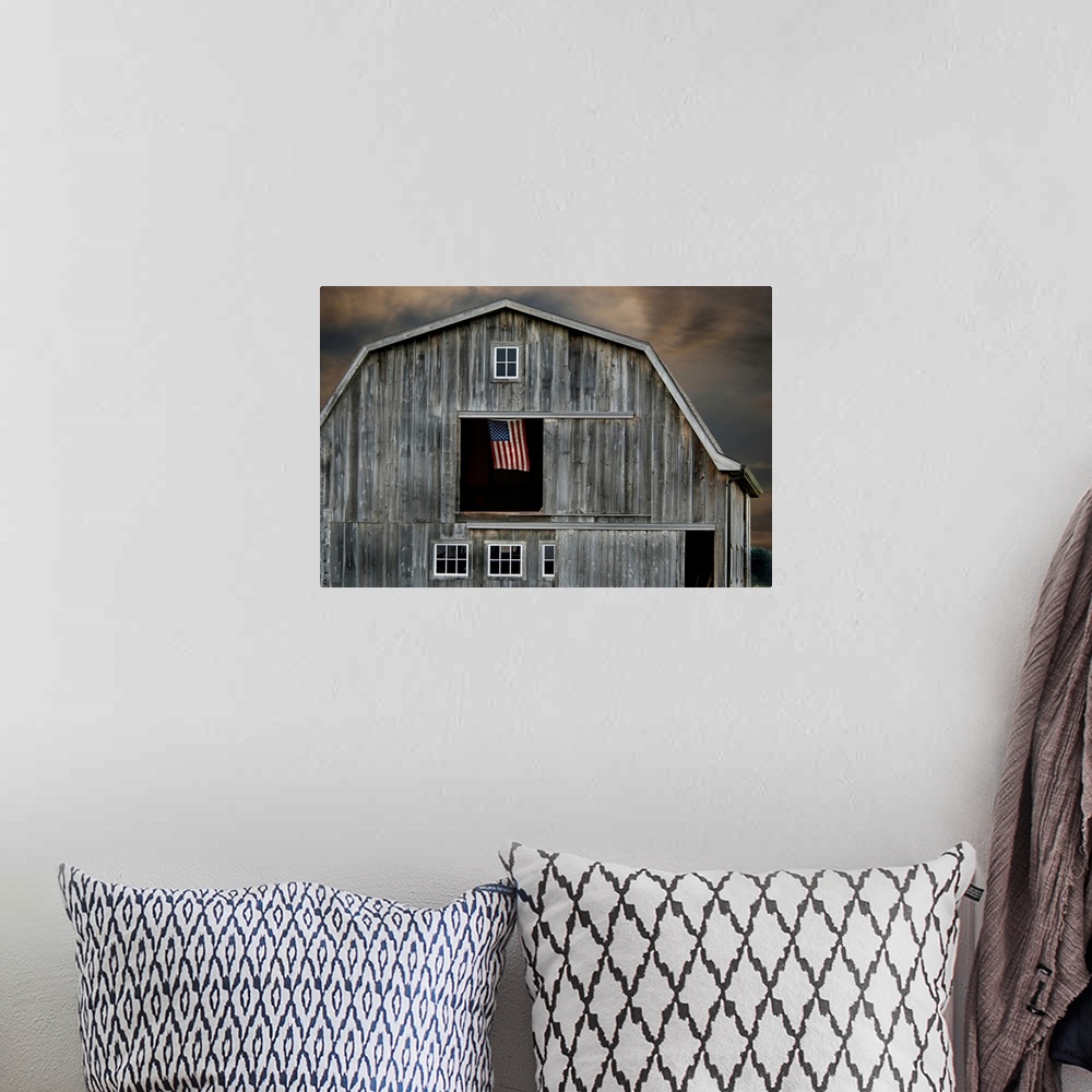 A bohemian room featuring Flag flying in hay loft of old barn.