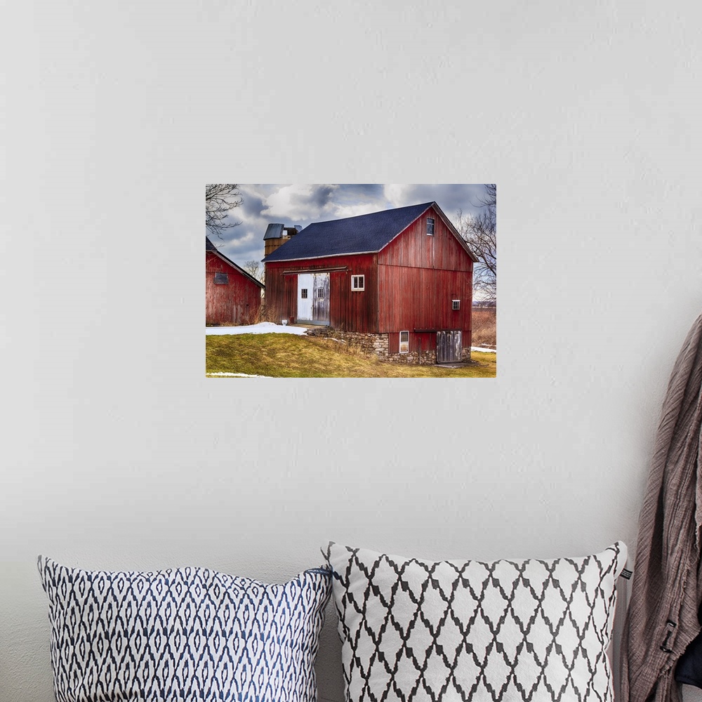 A bohemian room featuring Large red bank barn. New roof. Crisp colors and overcast sky.