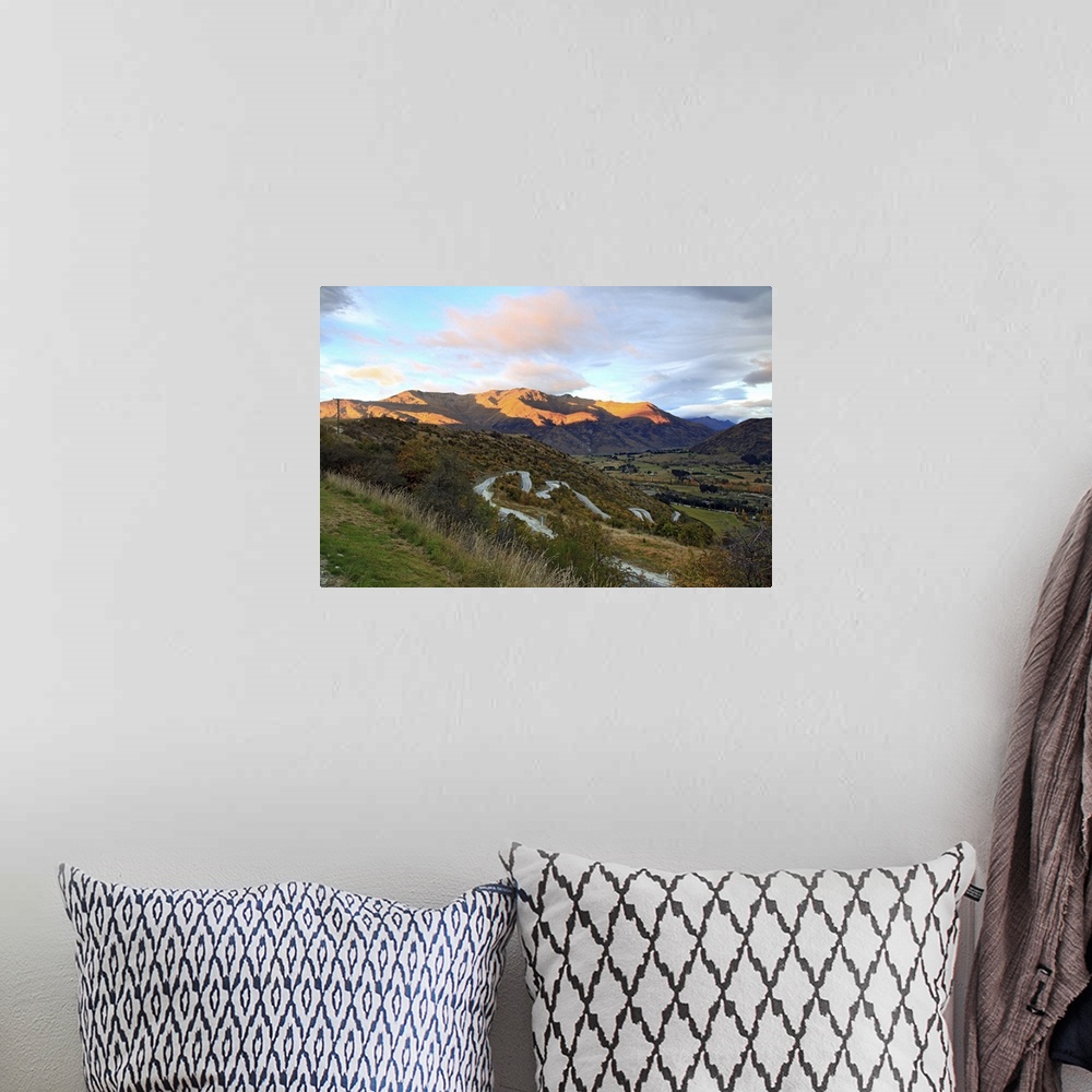 A bohemian room featuring Highway to Arrow Town with sunrise and mountain landscape in New Zealand.