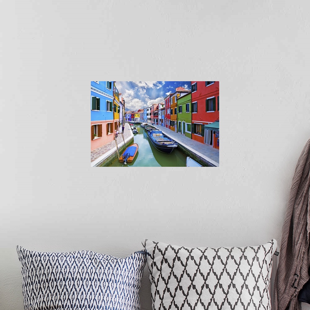 A bohemian room featuring Venice, Burano Island Canal. Small colored houses and the boats.