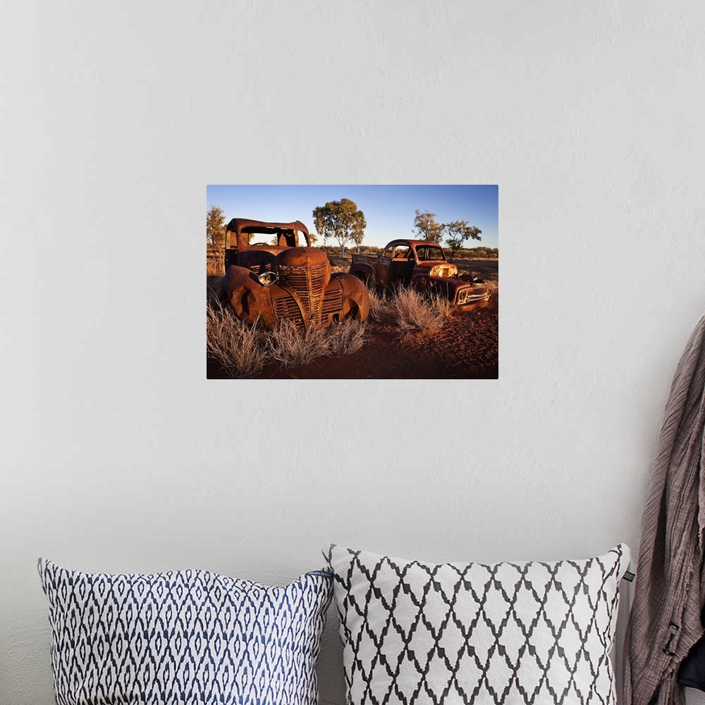 A bohemian room featuring Australia, Northern Territory, Oceania, Devil's Marbles, old car wreck in the desert
