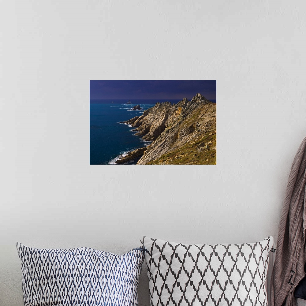 A bohemian room featuring A storm approaching the cliffs at Pointe du Raz, with the famous lighthouse out in the Atlantic o...