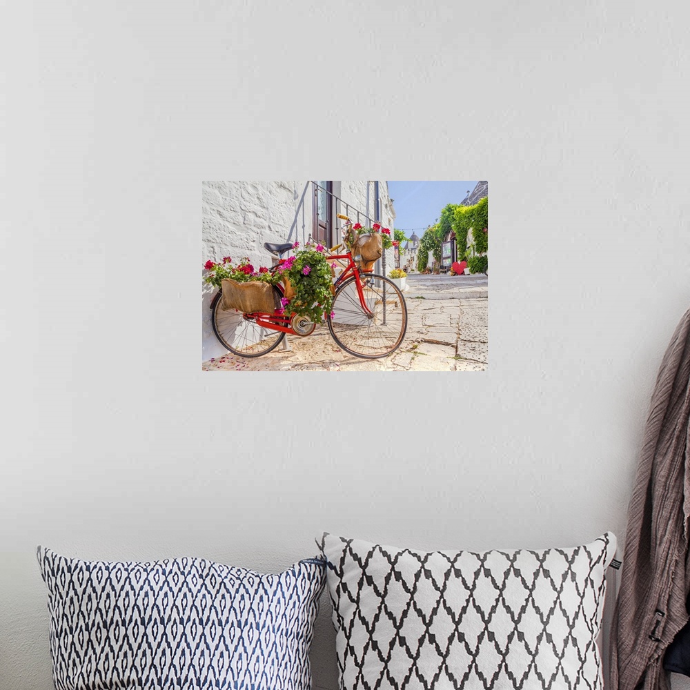 A bohemian room featuring Italy, Apulia, Bari district, Itria Valley, Alberobello, Bicycle in a typical street of Alberobello.