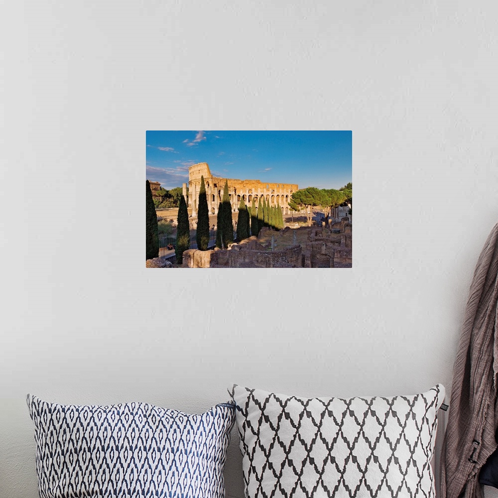 A bohemian room featuring Veduta del Colosseo dall'arco di Settimio Severo con in primo piano la via Sacra e le rovine del ...