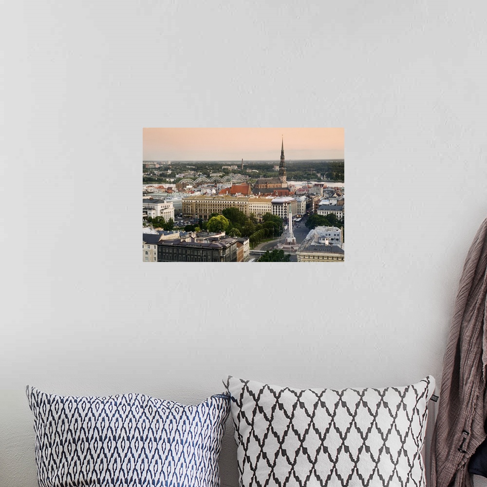 A bohemian room featuring Latvia, Riga, Cityscape with view of the Freedom Monument and St Peter's Church