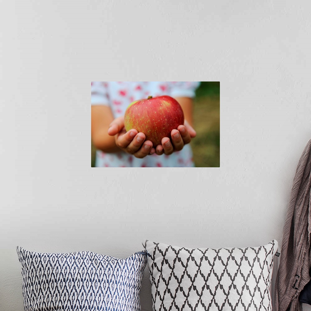 A bohemian room featuring Girl Holding Red Apple