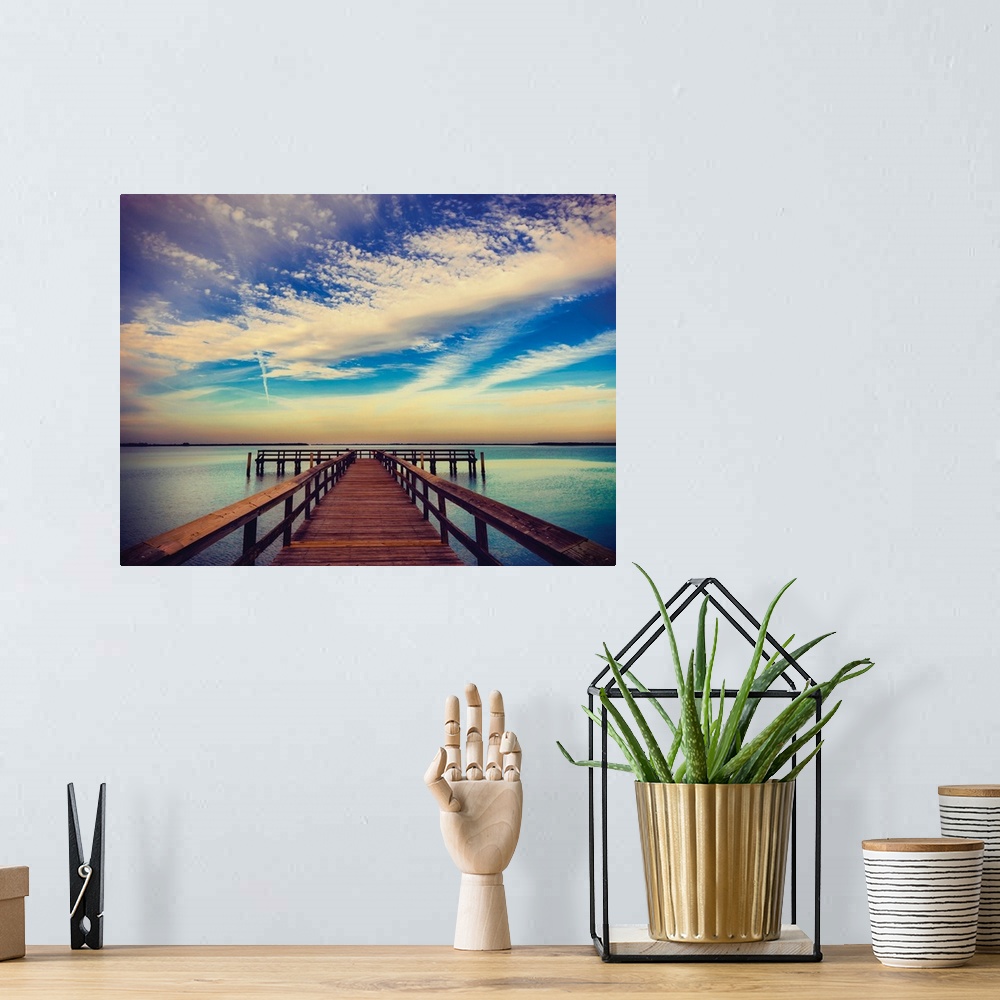 A bohemian room featuring Photograph of a pier at sunrise with beautiful clouds.