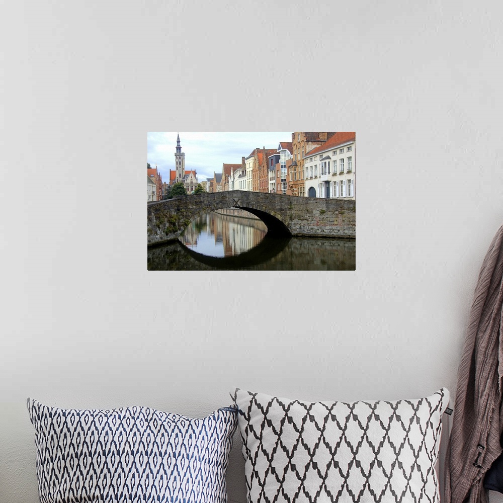 A bohemian room featuring Photograph of an old stone bridge in Belgium over a river.