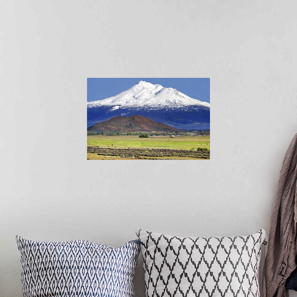 A bohemian room featuring Landscape photograph of rural fields with a snow covered Mount Shasta in the background.