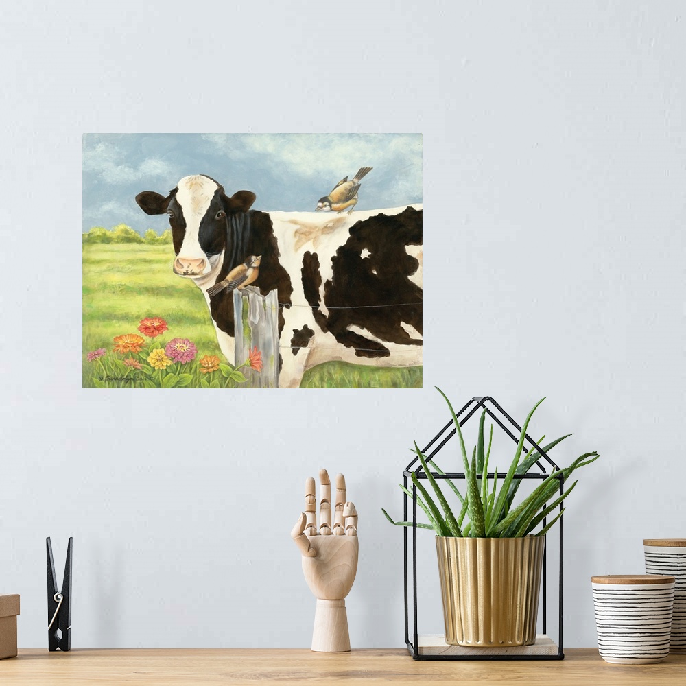 A bohemian room featuring Contemporary painting of a cow with a bird on its back standing in a field behind a wire fence.