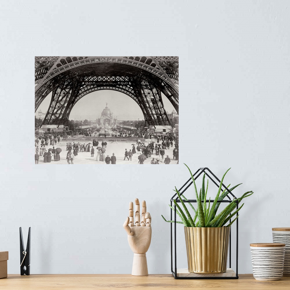 A bohemian room featuring Vintage photograph of people standing under the base of the Eiffel Tower in Paris.