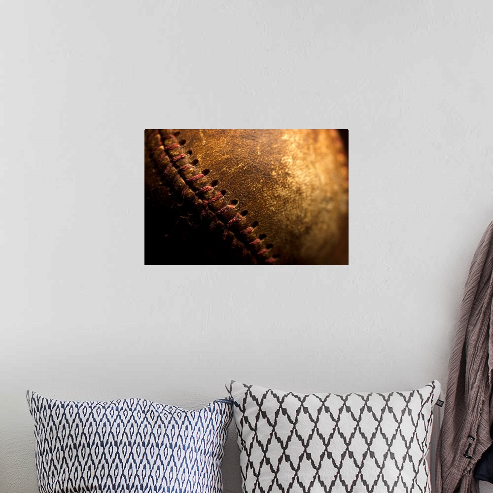 A bohemian room featuring A closeup of an old baseball. Shot with shallow depth of field.