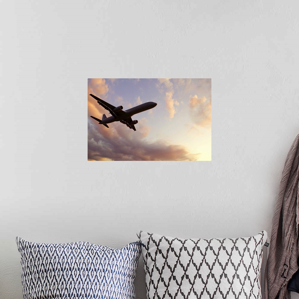 A bohemian room featuring A silhouetted airplane flies among a few clouds