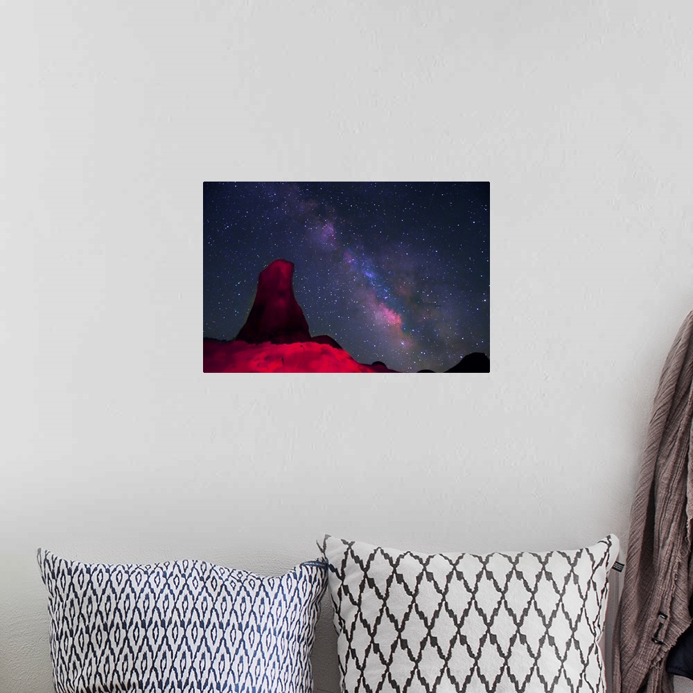 A bohemian room featuring Night at Alabama hills, rock tower light painted with red light with stars and Milky way in sky b...