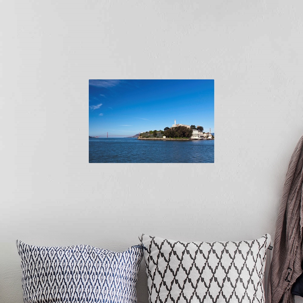 A bohemian room featuring Alcatraz island and rock and Golden Gate bridge on bright and sunny day.