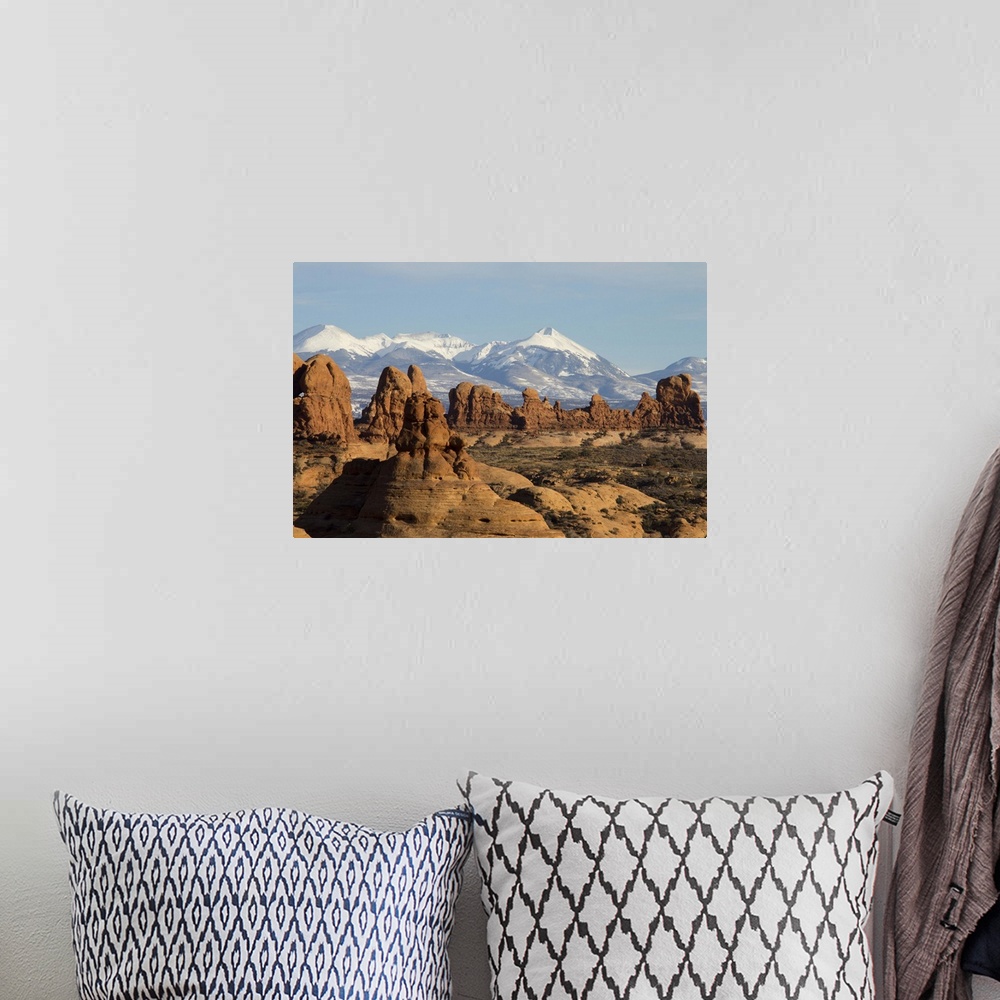 A bohemian room featuring The snow-capped montains of the La Sal Mountain range is visible in the background.