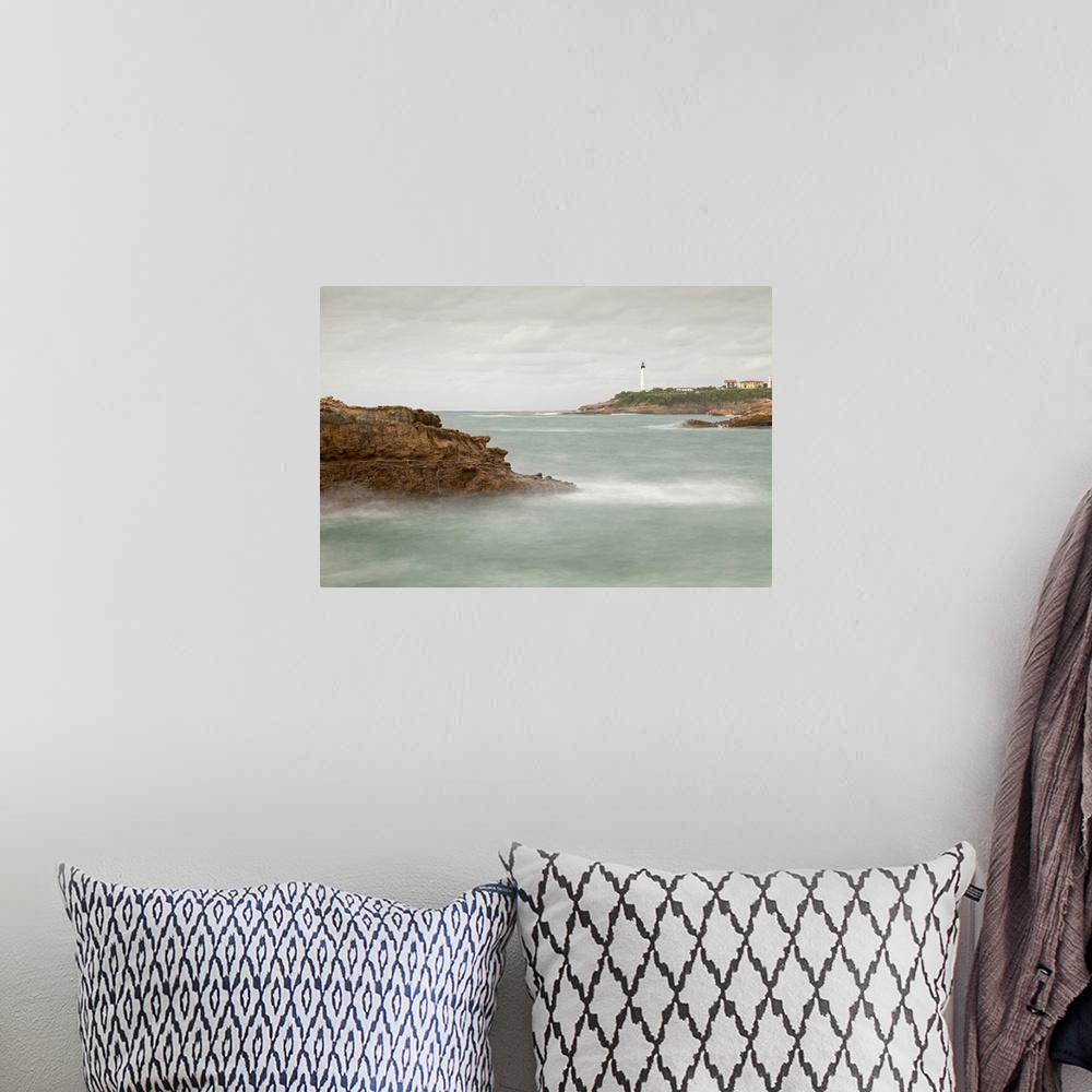 A bohemian room featuring Biarritz Lighthouse with rocks and sea.