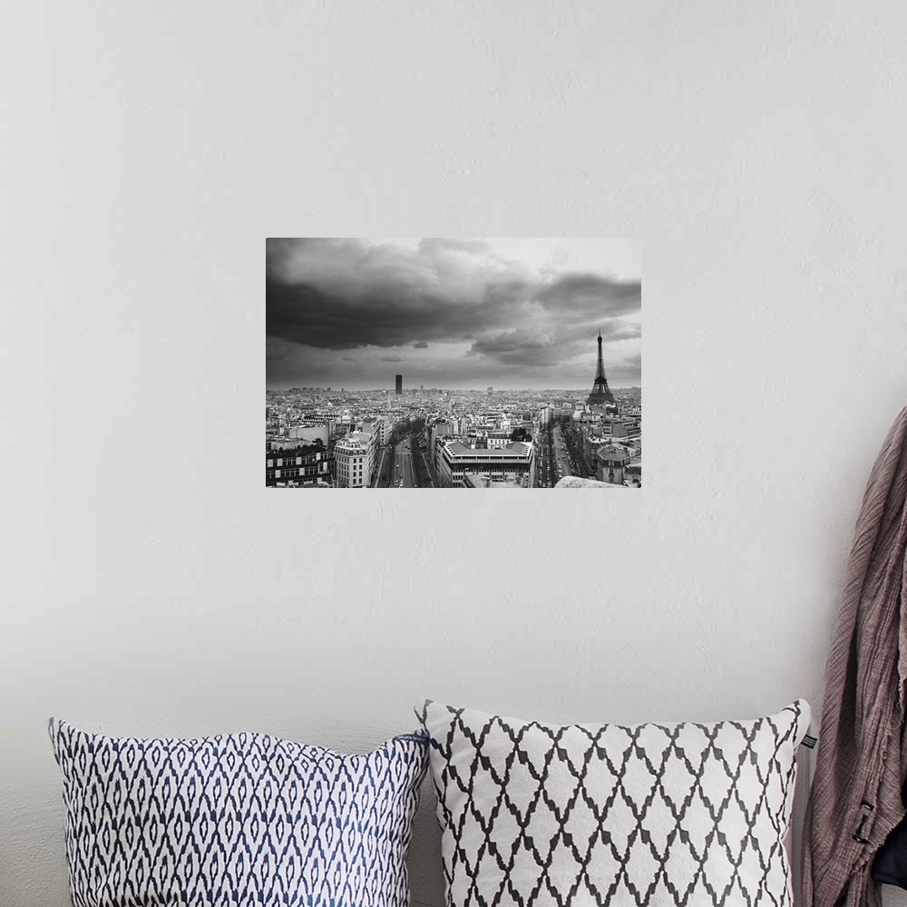 A bohemian room featuring black and white aerial view of an overcast sky above the Eiffel tower