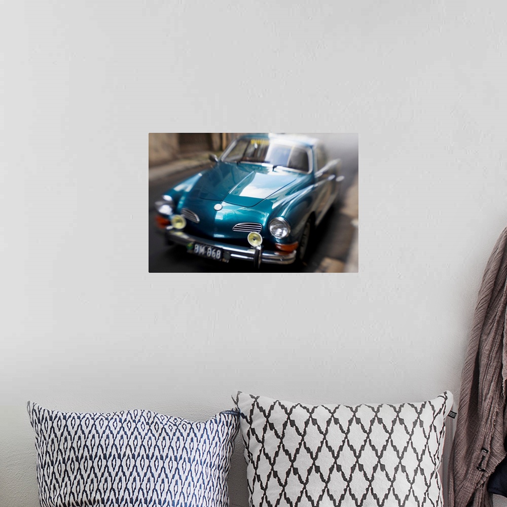 A bohemian room featuring Blurred Motion Shot of a Metallic Blue Classic Car