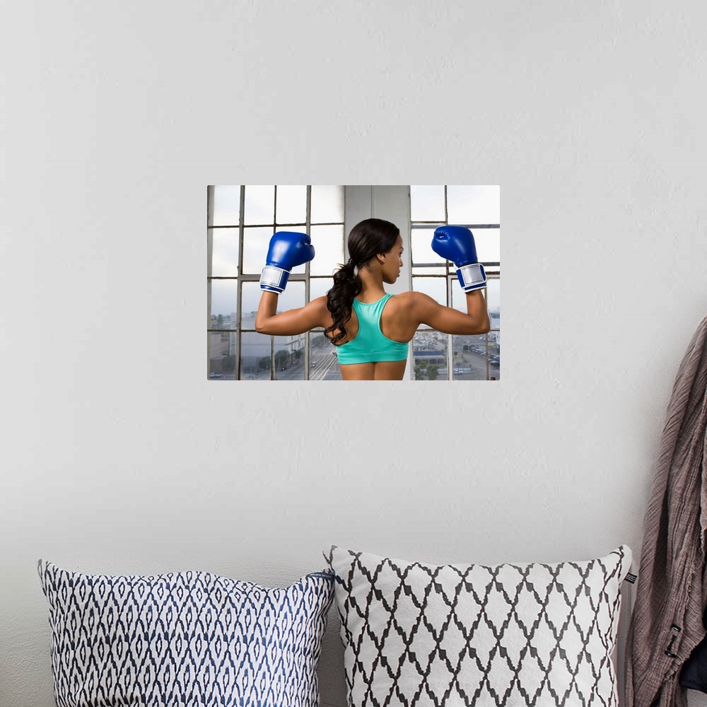 A bohemian room featuring Back view of boxer flexing muscles