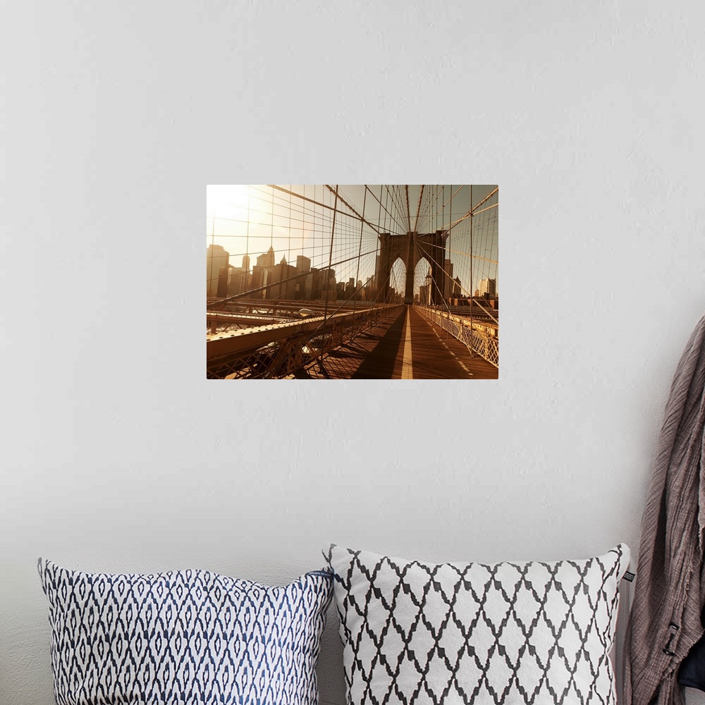 A bohemian room featuring Landscape, oversized photograph of the Brooklyn Bridge, taken through a multitude of cables, with...