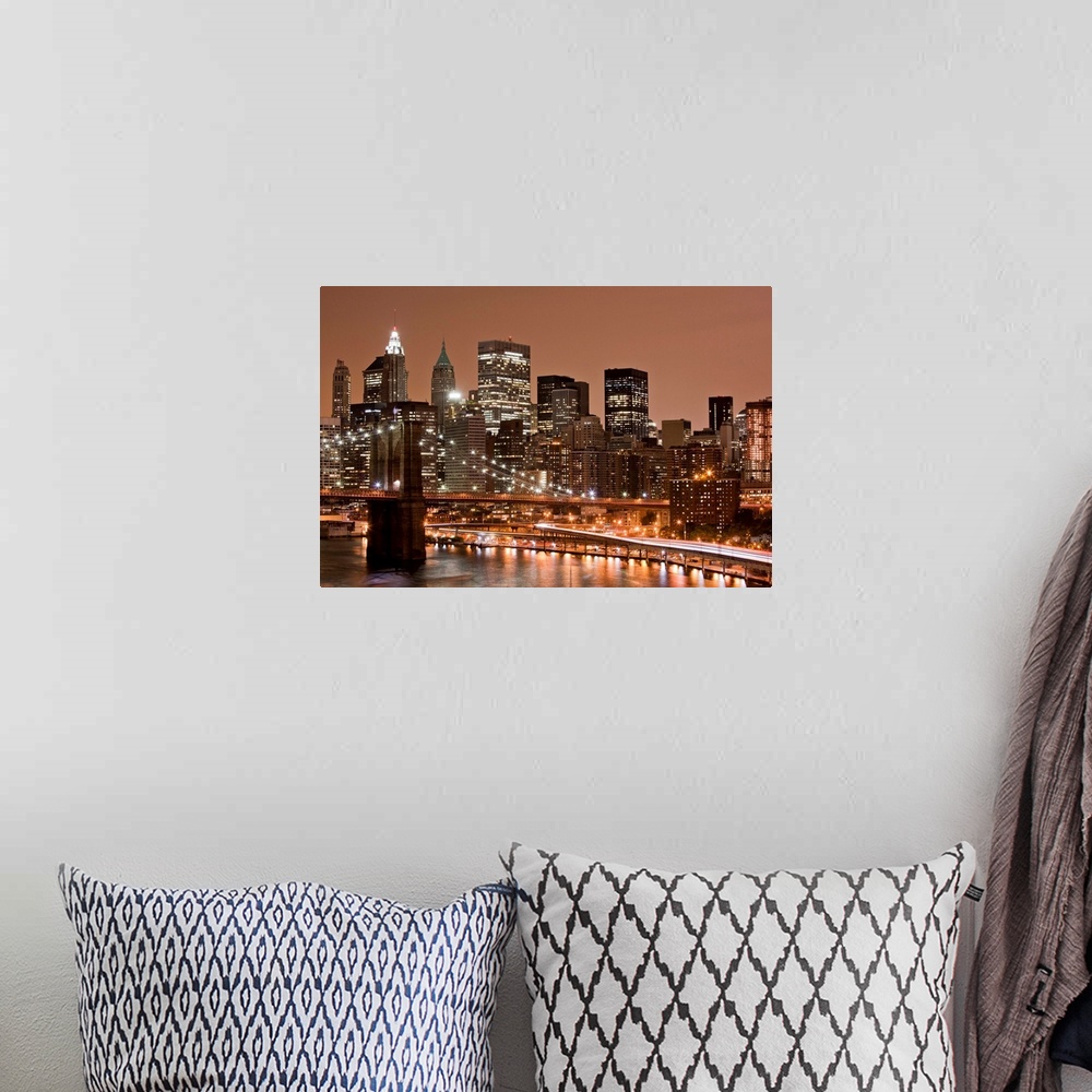 A bohemian room featuring USA, New York, Brooklyn, Brooklyn Bridge at night and East River with Lower Manhattan skyline glo...