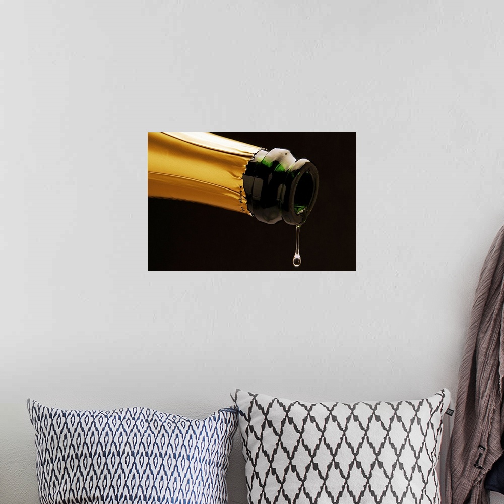 A bohemian room featuring Champagne drop dripping from bottle, close-up