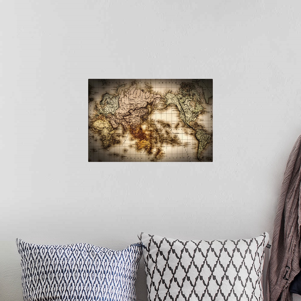 A bohemian room featuring Horizontal, large wall picture of an antique world map with a dark vignette around the edges, and...