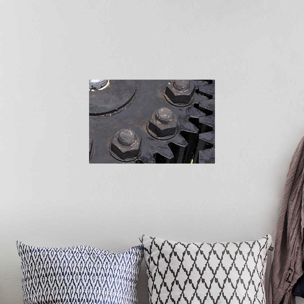 A bohemian room featuring Oversized, horizontal, close up photograph of the teeth meeting on two large metal gears. Large b...