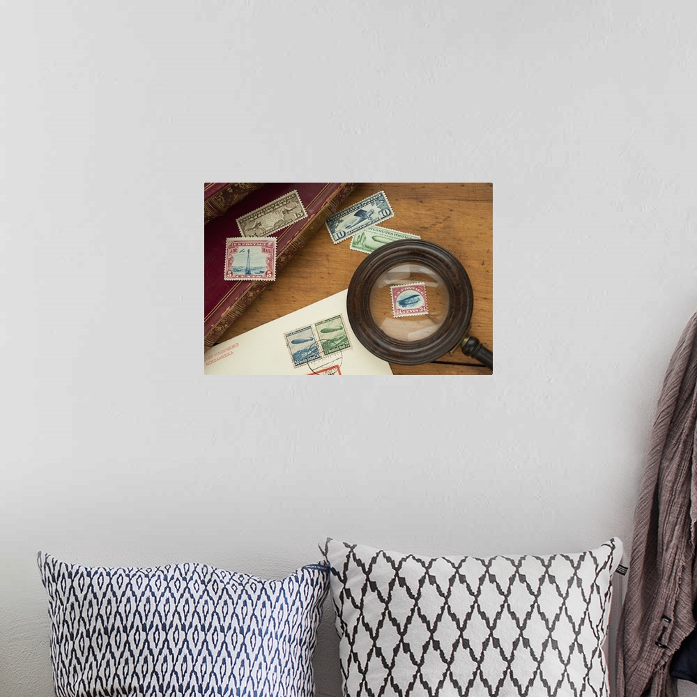 A bohemian room featuring Close up of stamps collection and magnifying glass