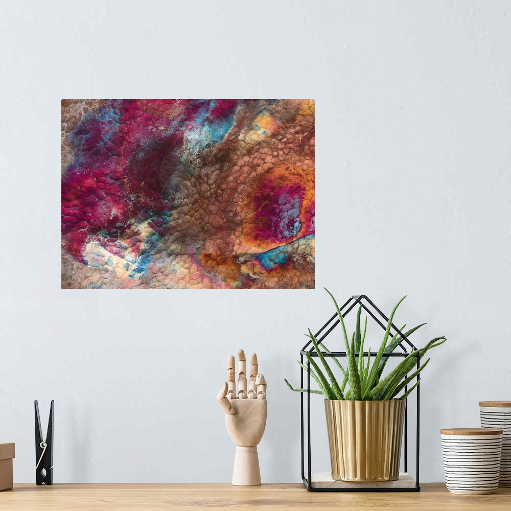 A bohemian room featuring Abstract artwork of a piece of metal that has various colors swirled around it.