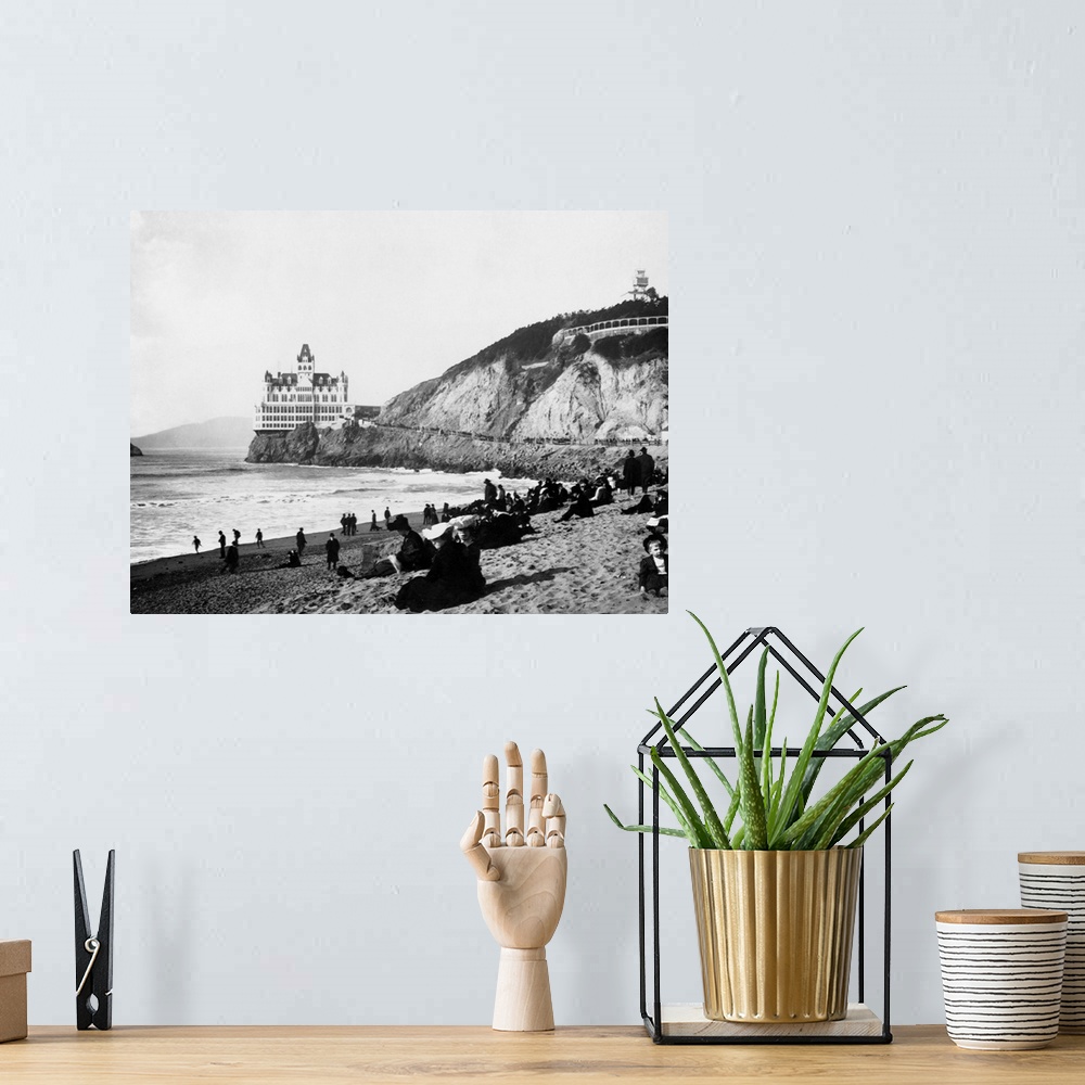 A bohemian room featuring A crowd of people on the beach below the Cliff House enjoy the sun, the surf, and a view of Seal ...