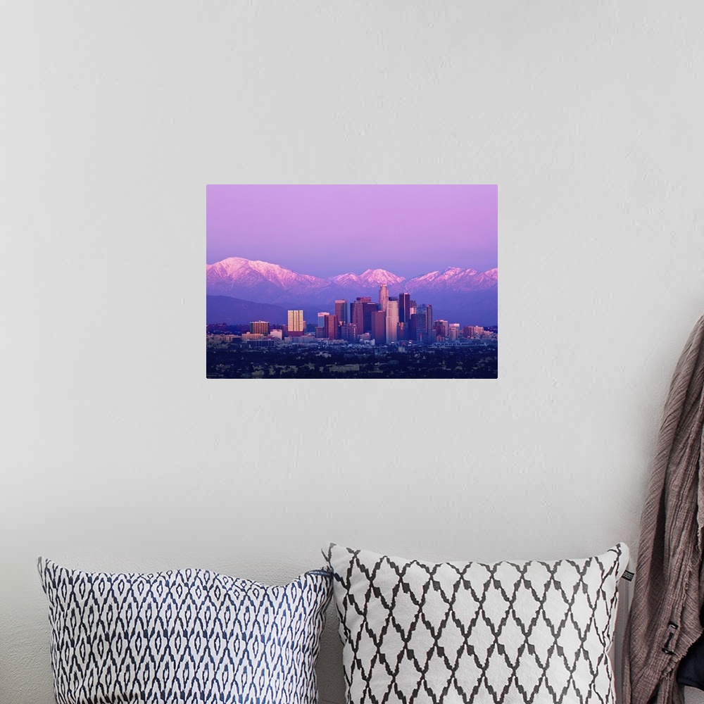 A bohemian room featuring Downtown Los Angeles and sunset. Buildings are lit from setting sun and mountains are capped with...
