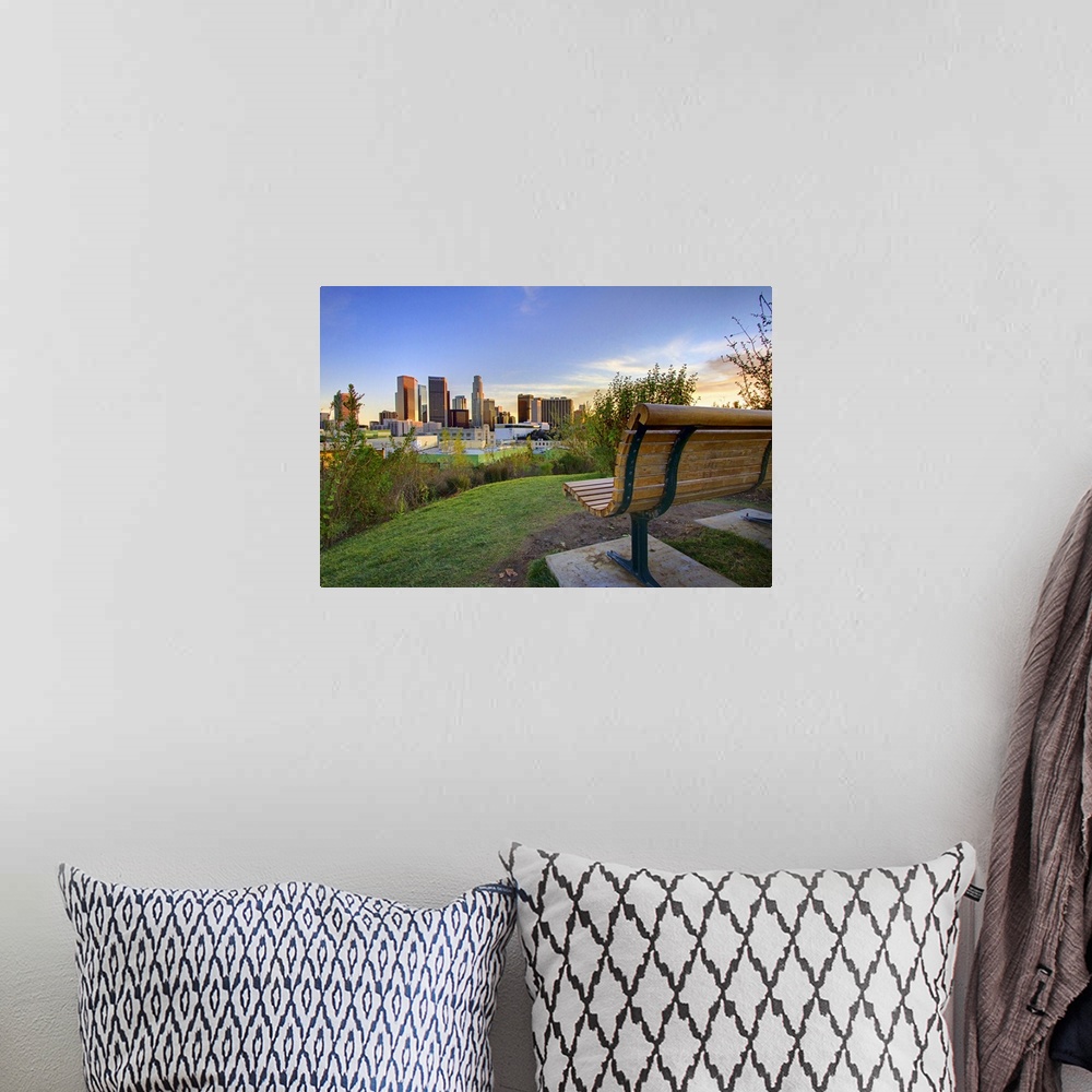 A bohemian room featuring Photograph of park bench overlooking city skyline at dusk.