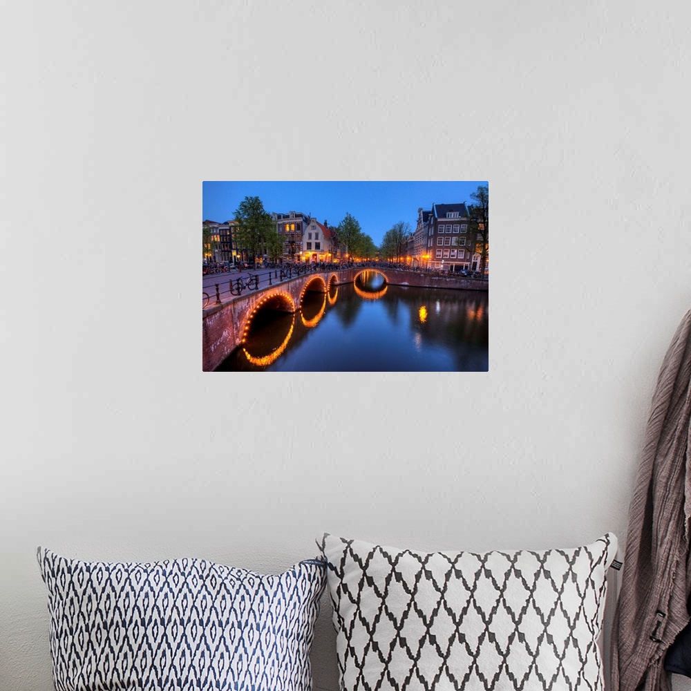A bohemian room featuring Evening light old buildings and bridge along the many Canals of Amsterdam, Netherlands, at dusk t...