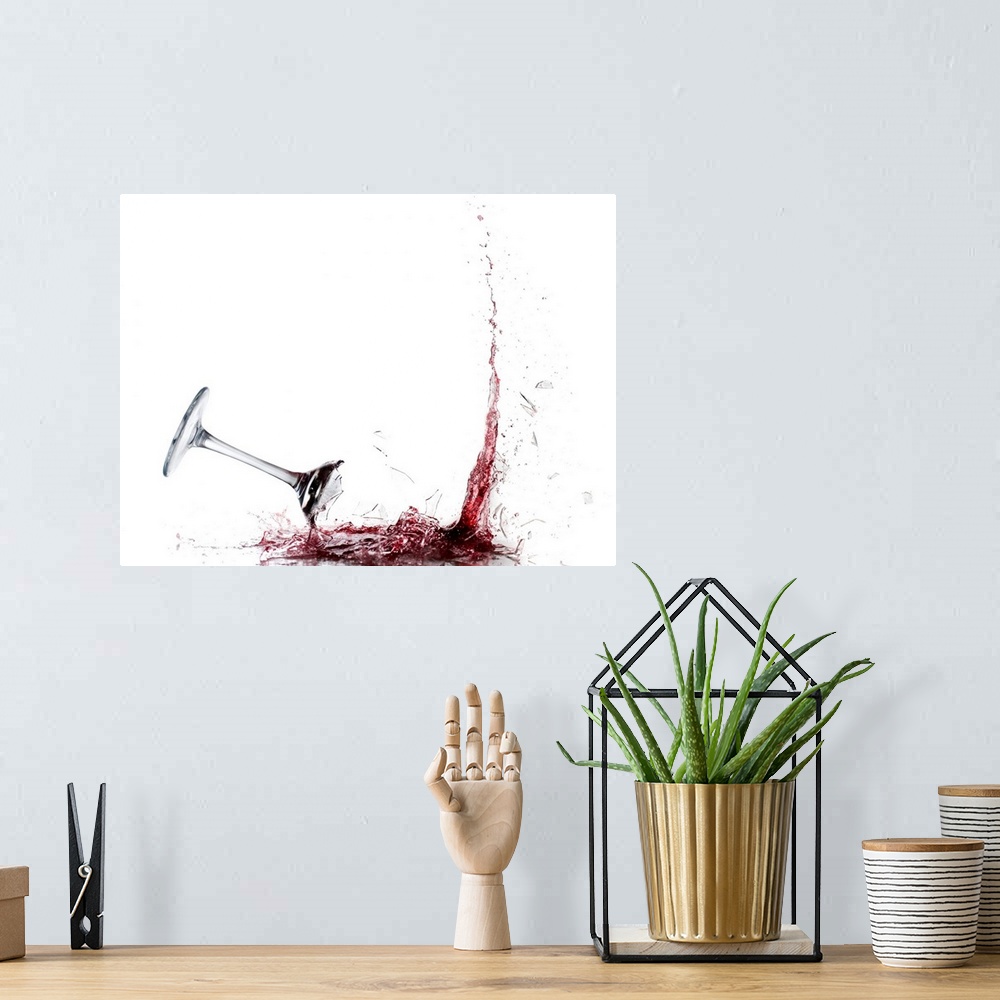 A bohemian room featuring Giant photograph displays a piece of stemware filled with vino as it crashes into the ground and ...