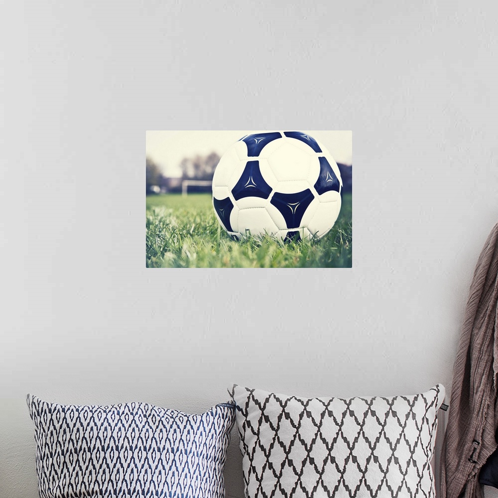 A bohemian room featuring Football on football pitch with goal in distance.