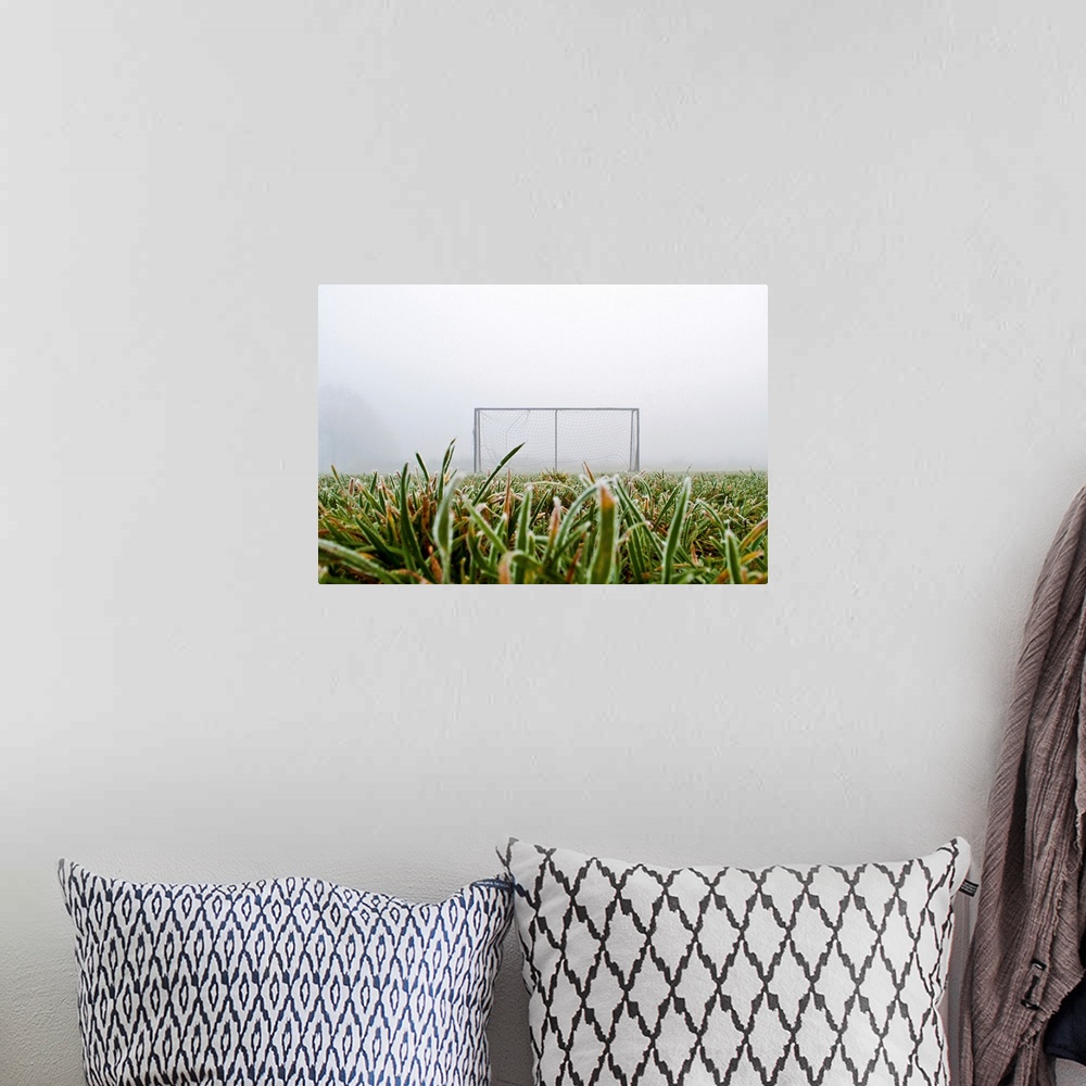 A bohemian room featuring Frost and fog and football goal on soccer field.