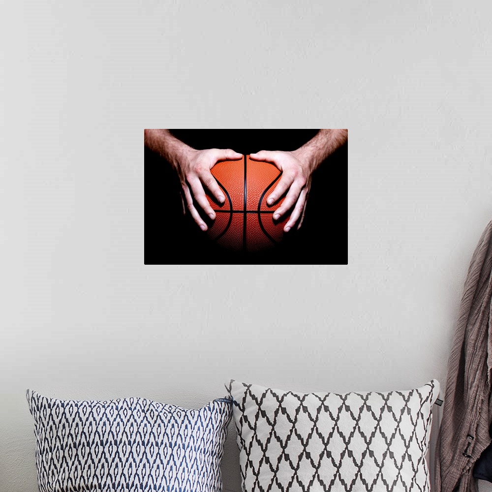 A bohemian room featuring Hands holding a basketball