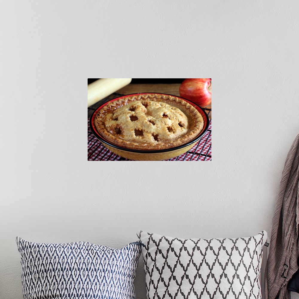 A bohemian room featuring Home baked apple pie on cooling rack with apple and rolling pin