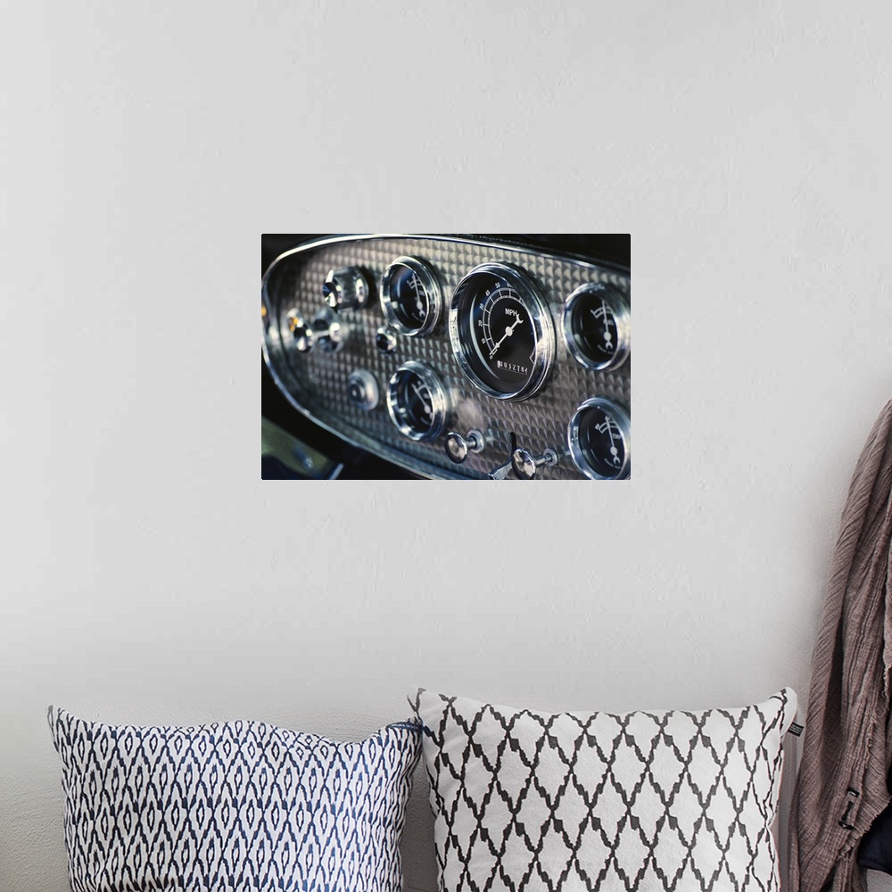 A bohemian room featuring Horizontal, close up photograph on a big canvas of a chrome and black, rounded instrument panel o...