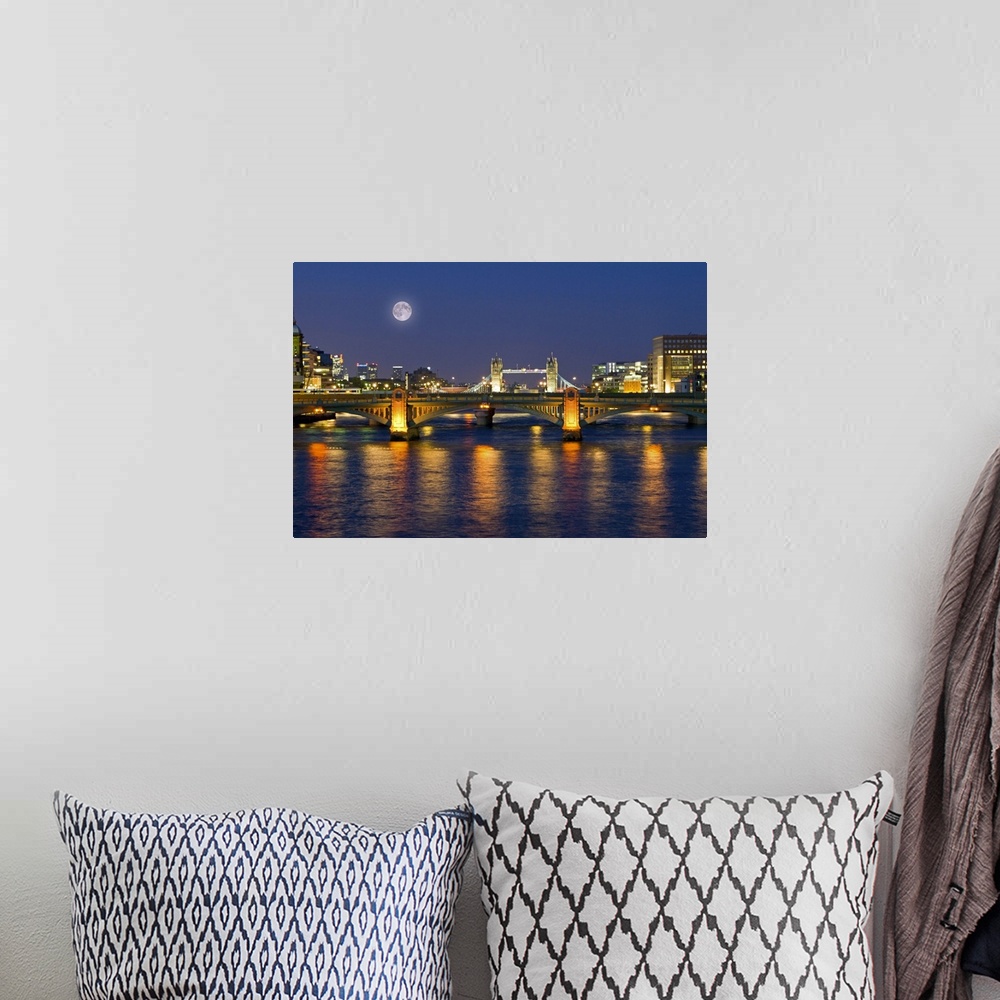 A bohemian room featuring Horizontal photograph on a giant wall hanging of the Millennium Footbridge, lit at night over the...