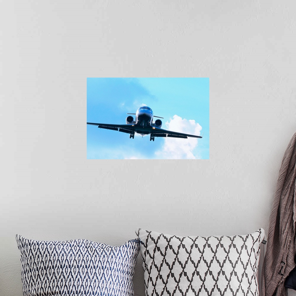 A bohemian room featuring low angle frontal view of an aircraft in descent