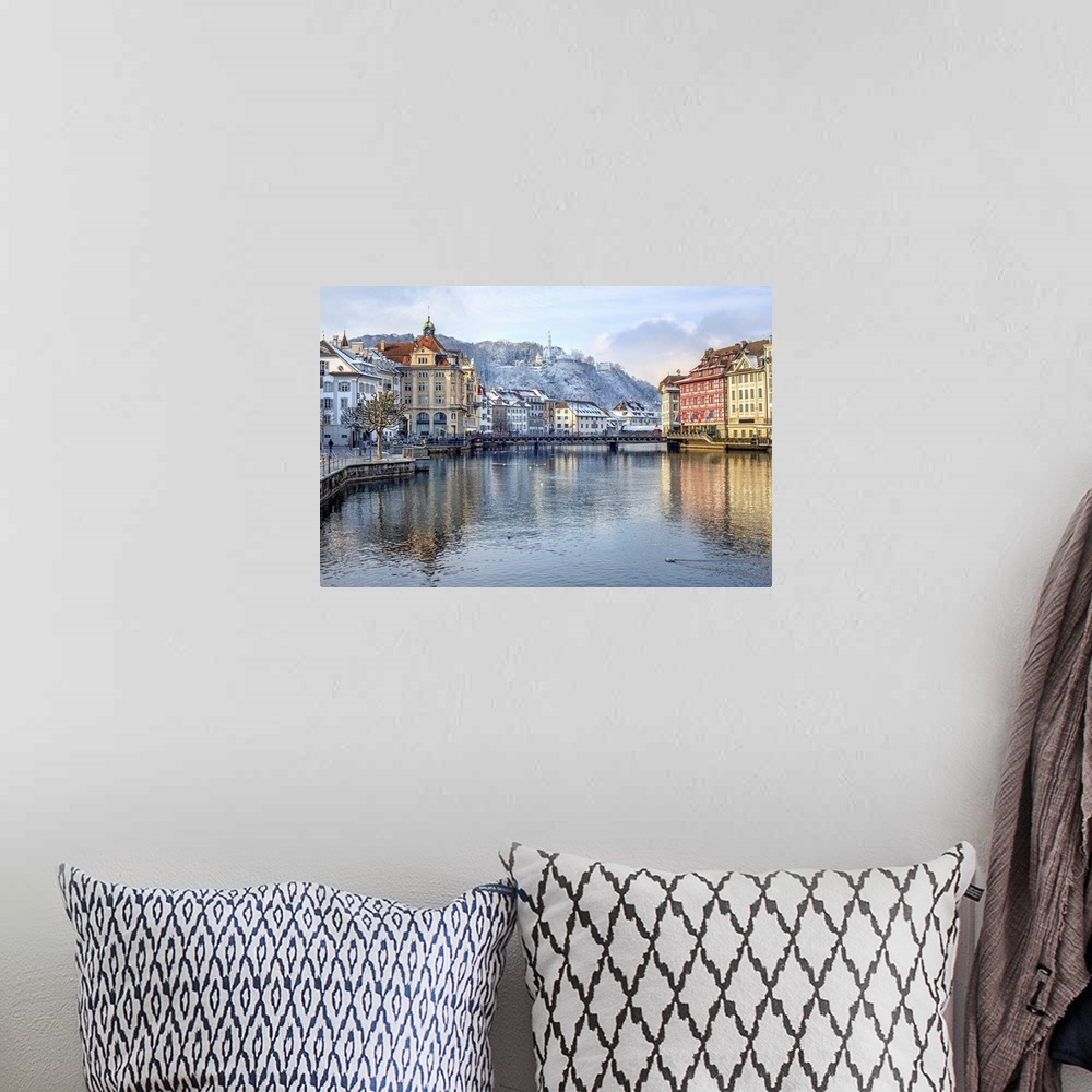 A bohemian room featuring Lucerne city, Switzerland, view of the Old Town covered with white snow in winter, reflecting in ...