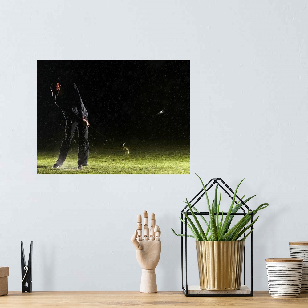 A bohemian room featuring Man playing golf, hitting ball